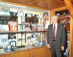 Norman and his collection of baseball memorabilia. Norman and his collection of baseball memorabilia.